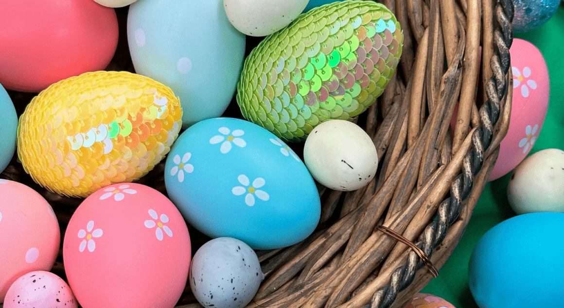 A wicket basket of brightly colored Easter eggs. Some of the eggs have shiny scales.